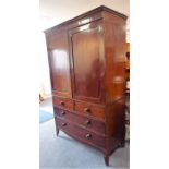 An early 19th century Regency-period mahogany linen press; two panelled doors enclosing slides and