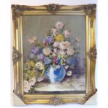 L SUTTON; a gilt-framed oil on artist's board still-life study of roses and other flowers in an