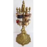 A 19th century gilt-brass bobbin stand with two tiers of cotton bobbins; the centre supported by a