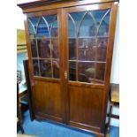 A fine quality Georgian-style mahogany display cabinet; the dental cornice above two doors each with