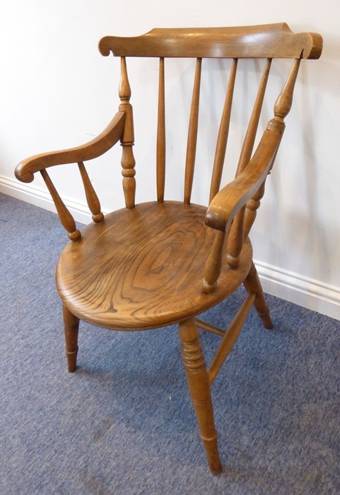 An early 20th century desk-style chair having oval elm seat