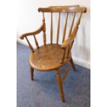 An early 20th century desk-style chair having oval elm seat