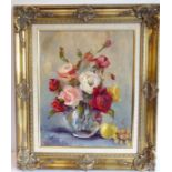 L SUTTON; gilt-framed oil on artist's board still-life study of roses in a vase, signed Sutton,