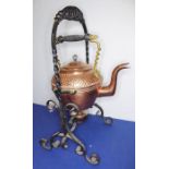 An early 20th century Arts & Crafts-style copper spirit kettle upon a wrought-iron stand (height