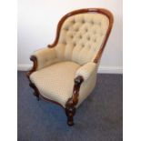 A good mid-19th century button-back-upholstered and mahogany-framed armchair; scrolling arms,