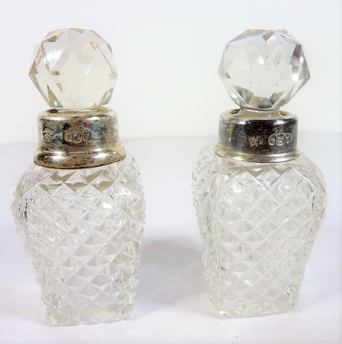 A pair of cut-glass silver-mounted scents Condition Report: The first scent - the silver mount on