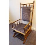 An early 20th century American-style rocking chair; the stained show-wood carved as faux