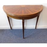 A demi-lune walnut card table in late 18th century French-style (later); sunburst-style top above