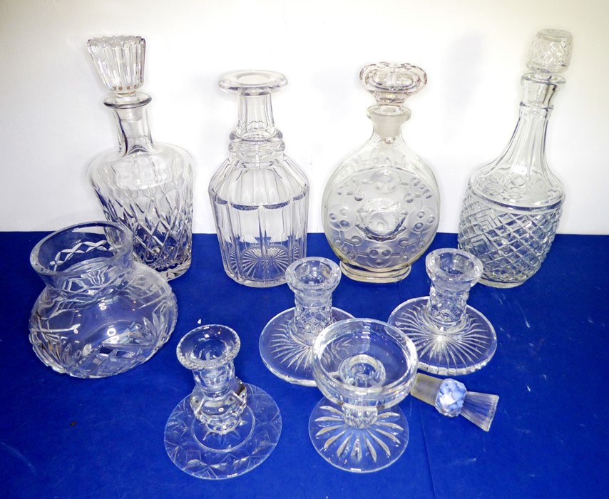 A selection of mostly cut glassware to include four decanters (25-29cm) and a pair of candlesticks