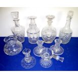 A selection of mostly cut glassware to include four decanters (25-29cm) and a pair of candlesticks