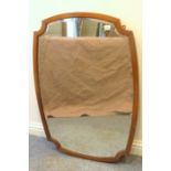 An early 20th century mahogany-framed wall-hanging looking glass with re-entrant-style corners (