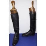A pair of gentleman's black-leather hunting boots with wooden trees