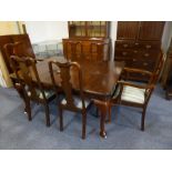 A large early 20th century extending mahogany dining table having two extra leaves, raised on four