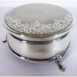 A hallmarked silver and velvet-lined circular jewellery box; flip-up lid with engine-turned and