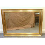 A gilt-framed wall-hanging looking glass having hand-bevelled plate (frame dimensions 71cm x 101cm)