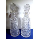 A pair of finely hand-cut early 20th century heavy crystal decanters of conical form; small