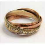 A three-colour 9-carat gold and diamond Russian wedding ring; assayed London 1989, ring size N (