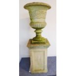 A good verdigrised stoneware campana-style urn; decorated in relief with scrolling foliage and
