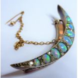 A 19th century crescent-shaped rose-gold brooch; set with graduated oval opals on cabochon