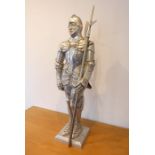 A heavy cast-iron fire companion set modelled as a knight in armour (approx. 78cm high)