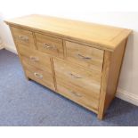 A modern light-oak side chest; three small top drawers and sets of two half-width drawers below,