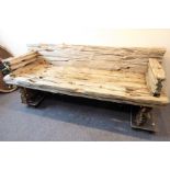 A teak driftwood garden bench