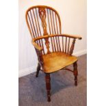 A good early to mid-19th century Windsor armchair; yew-wood bow and supports, pierced splat,
