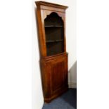 An 18th century style walnut freestanding corner cupboard; outset cornice above shelves and the base