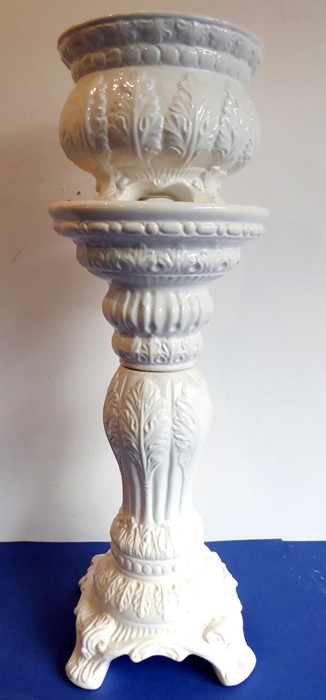 A white ceramic planter and stand