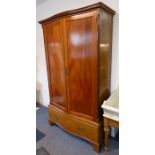 A good early 20th century serpentine-fronted mahogany wardrobe; maker's label of Cooper & Holt,