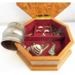 An octagonal wooden jewellery box containing mostly silver jewellery  (The cost of UK postage via