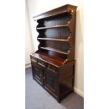 A good 19th century oak dresser; the superstructure with flaring cornice above shelves, and the base