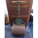 An early 20th century garden roller; green-painted cast-iron and turned wooden handles