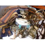 A bag of various tack to include tail protector, brushing boots, string reins, string girths,