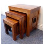 A nest of three modern hardwood occasional tables, each with lattice-work sides