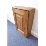 An antique pine wall hanging cupboard having single panelled door (42cm wide)