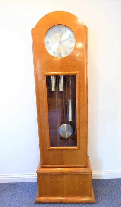 An unusual maple longcase clock in Biedermeier-style; the silver dial with Arabic numerals and