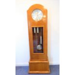 An unusual maple longcase clock in Biedermeier-style; the silver dial with Arabic numerals and