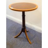 A reproduction circular topped mahogany wine table; satinwood cross-banded top and satinwood-fronted