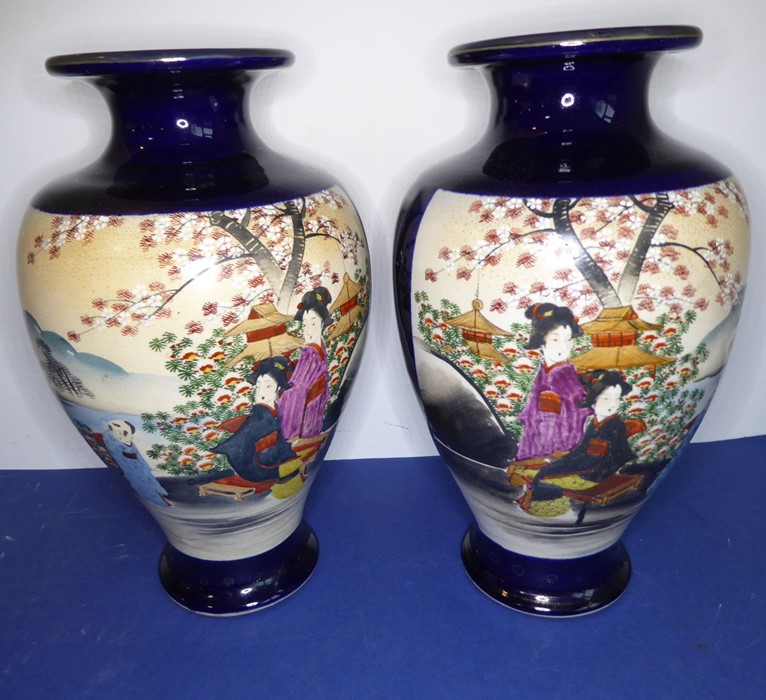 An opposing pair of early 20th century Japanese baluster-shaped pottery vases; each hand-decorated