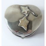 An early 20th century heart-shaped hallmarked silver trinket box; the interior blue-silk-lined and