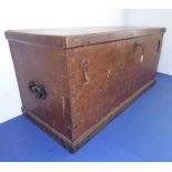 A 19th century oak trunk; the lid with strap hinges above an oval metal escutcheon and the ends with