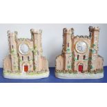 A pair of 1860/70 pottery models of castles decorated with clock faces, small loss to the top of one