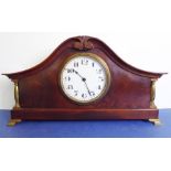 An early 20th century mahogany bicorn-shaped mantel clock in good working order; white dial with