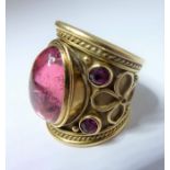 A 1970s pink tourmaline and 18-carat yellow gold 'Templar' ring by Elizabeth Gage; the central