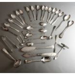 An assortment of silver flatware to include teaspoons, a baby's pusher, fish knives and tongs