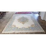 A large hand-knotted Indian woollen Malabar carpet; central white and blue oval with flower heads