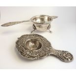 Two silver strainers: one with circular tripod stand, hallmarked and with 1977 Silver Jubilee
