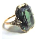 An Art Deco style gold ring set with a large green stone, possibly a green garnet, ring size L/M (