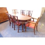 An early 20th century extending oval mahogany dining table having one extra leaf; gadrooned top